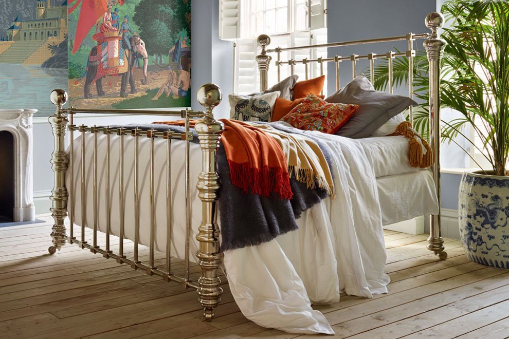 And So To Bed Dickens Bed seen from the foot end in a bright room with a mural