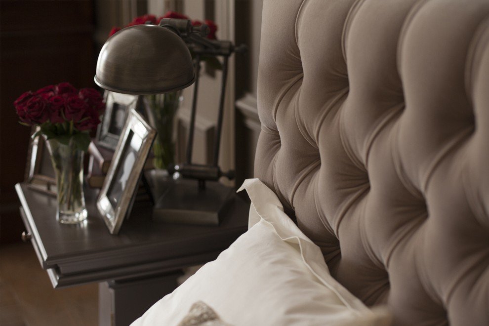 And So To Bed Emilia Ottoman Bed buttoned headboard beside a bedside table with a lamp