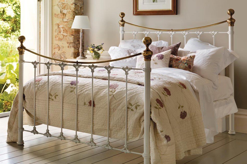And So To Bed Juniper Bed with floral bedding in a sunny garden room