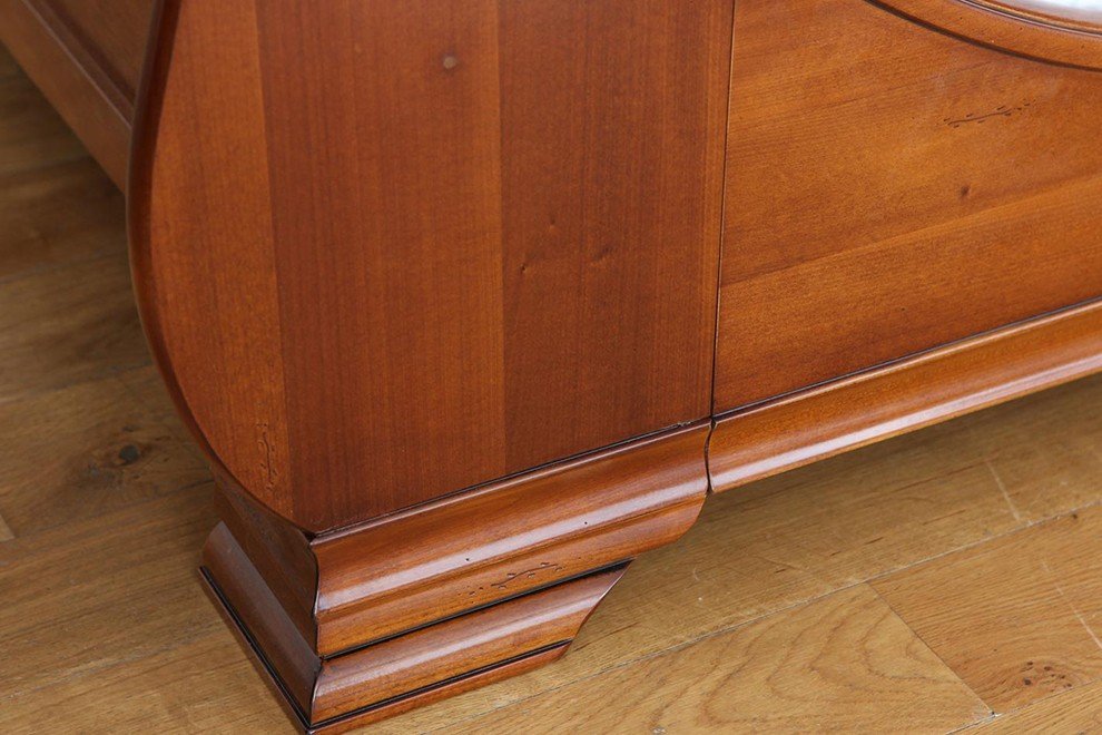 And So To Bed Manoir Bed close-up of the cherry veneer bracket foot on an oak floor