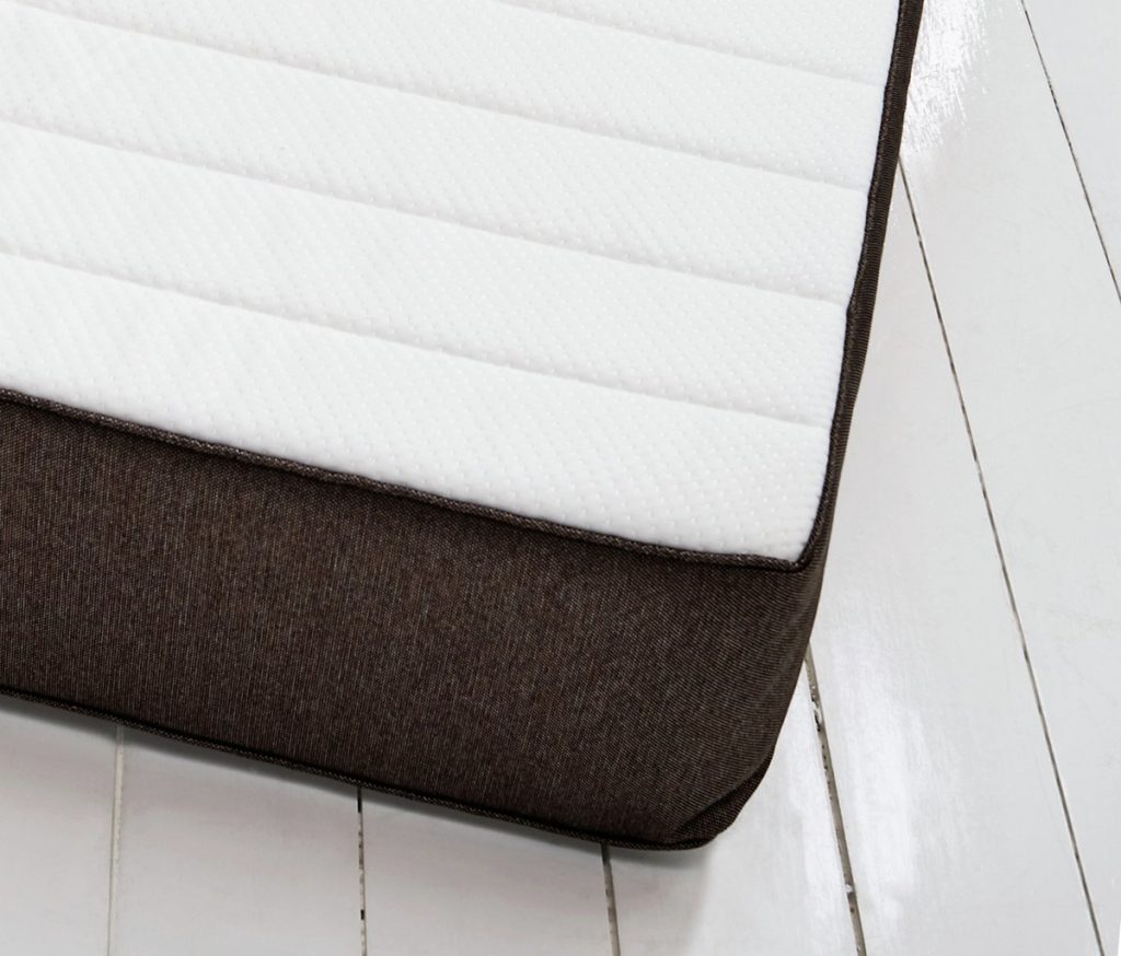 Argos Home Open Coil mattress, corner seen from the side on a white floor
