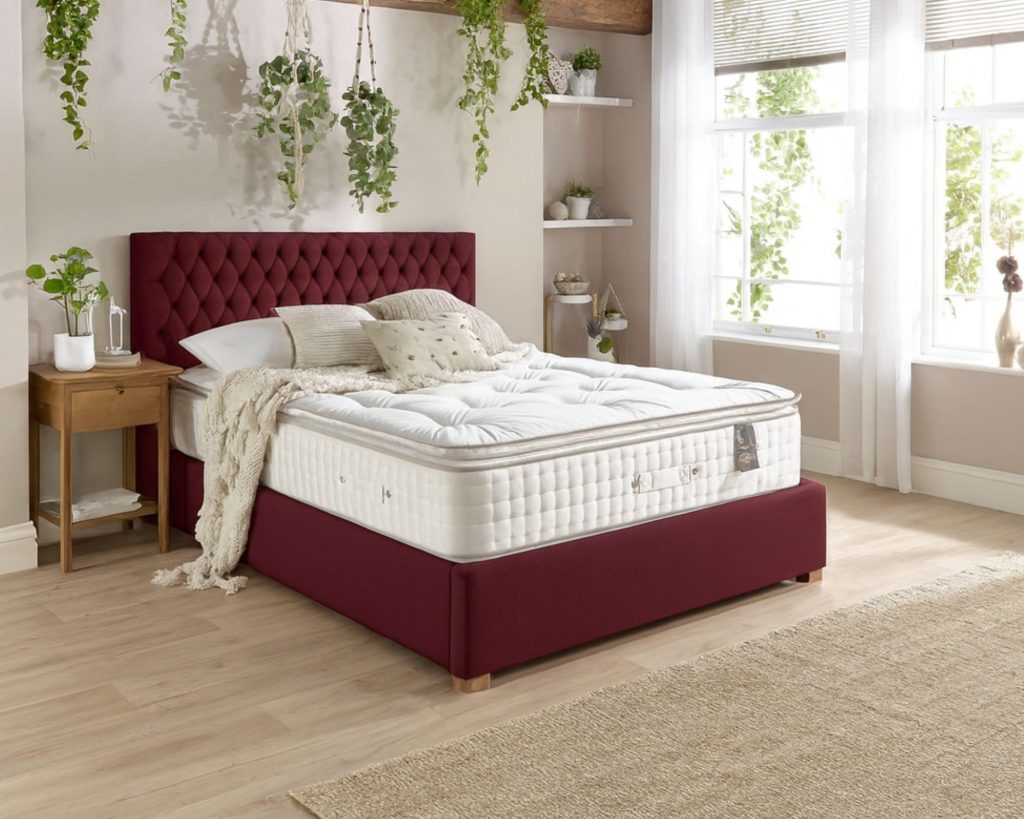 Aspire 7000 Pillowtop mattress on a red upholstered bed in a bright bedroom