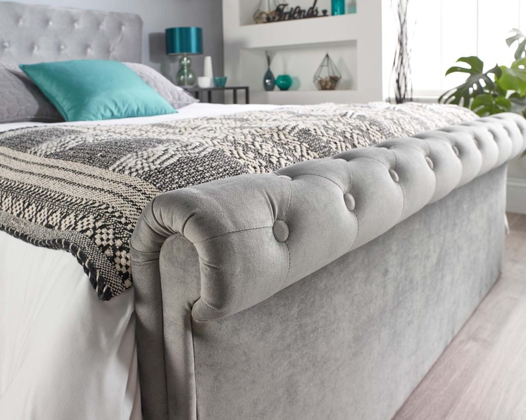 Aspire Scroll Top Chesterfield Ottoman Bed, scrolled velvet footboard close-up