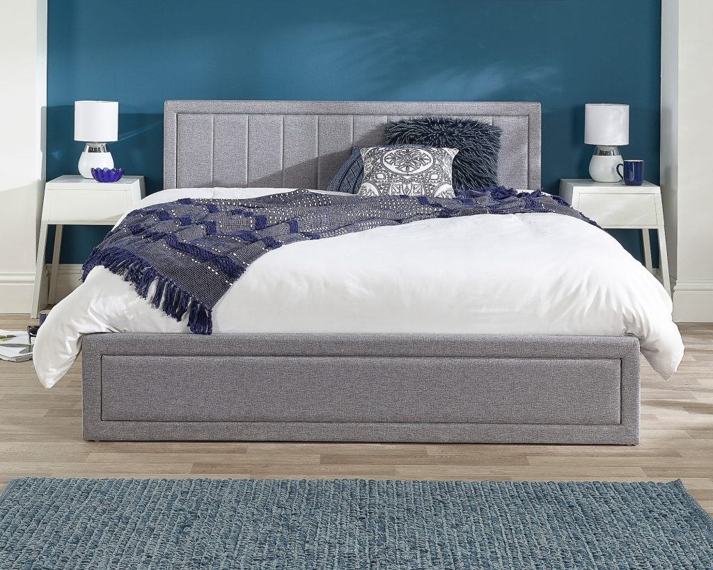Aspire Cotswold Quilted End Lift Ottoman Bed in grey linen seen straight on from the foot