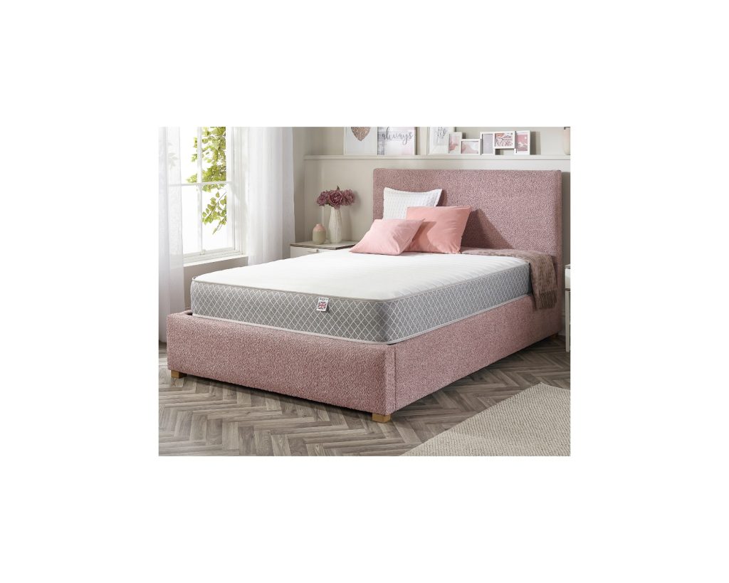 Aspire Dual Layer Pro Hybrid Rolled Mattress on a pink upholstered bed