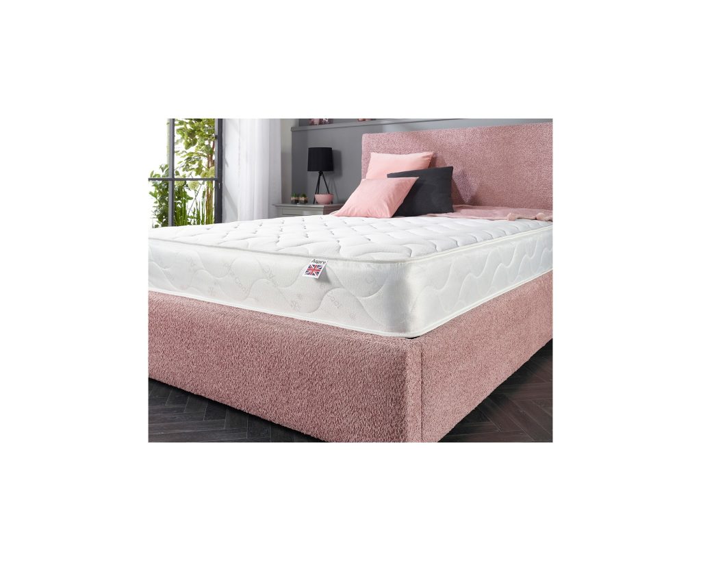 Aspire Eco Foam Rolled Mattress on a pink upholstered bed