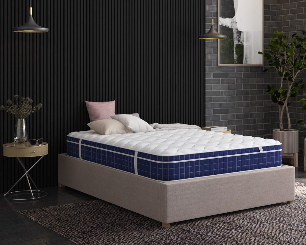 Aspire Invigorate Pocket Memory Foam Hybrid on a bed in a dark-panelled bedroom