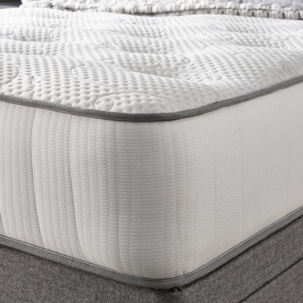 Corner of the Aspire Natural Cashmere Pocket Mattress with knitted top and grey piping