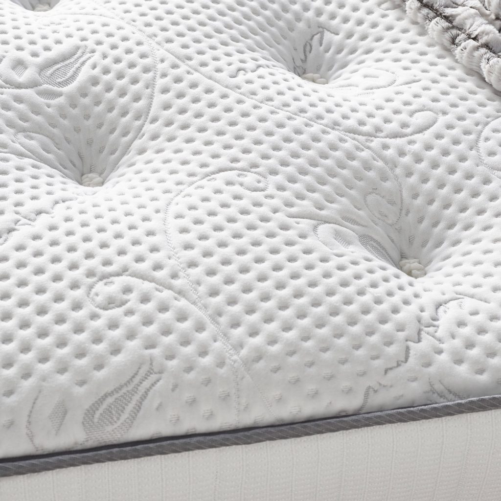 Close-up of the knitted, tufted sleep surface of the Aspire Natural Cashmere Pocket Mattress