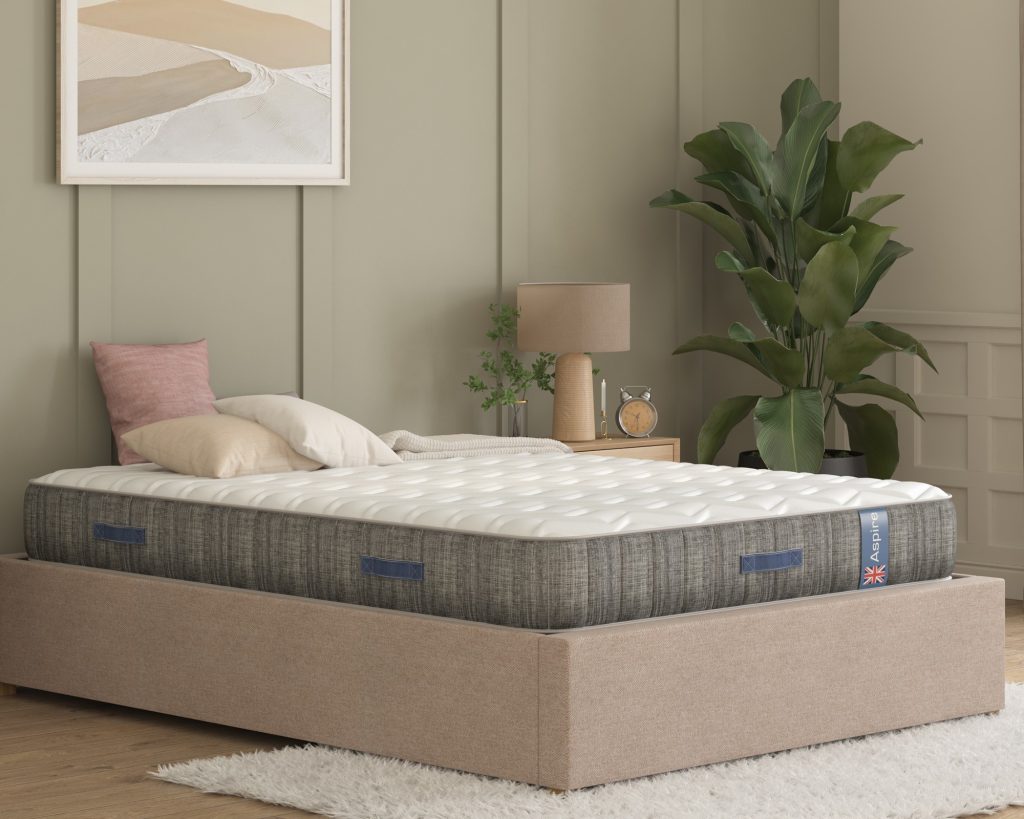 Aspire Natural Wool Pocket Eco Hybrid mattress on a beige bed, seen from an angle