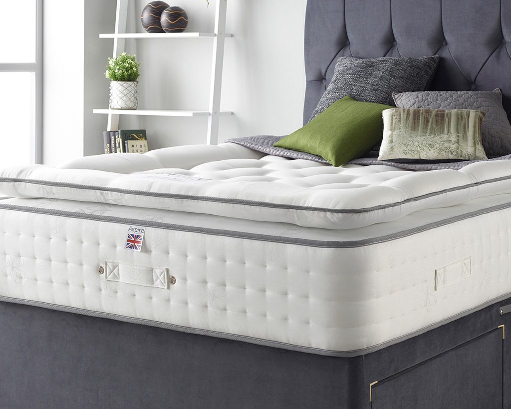 Aspire Pocket 1000 Memory Pillowtop with side handles, on a grey bed
