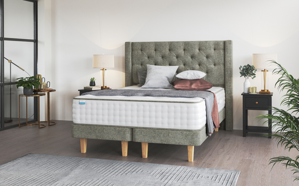 Dunlopillo Elite Supreme mattress on a grey bed with winged headboard in a bedroom