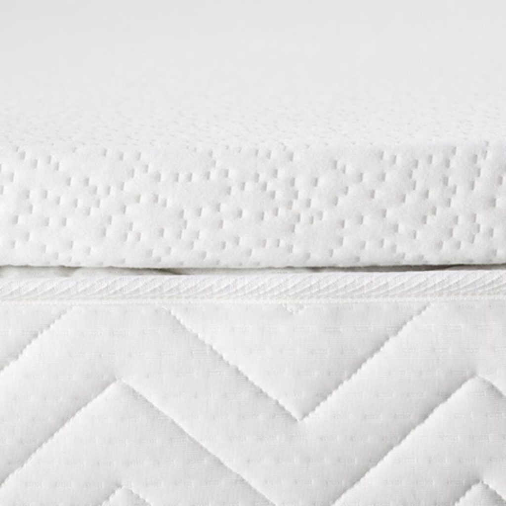 Side profile of a 5cm Duvalay custom topper in its quilted zipped cover