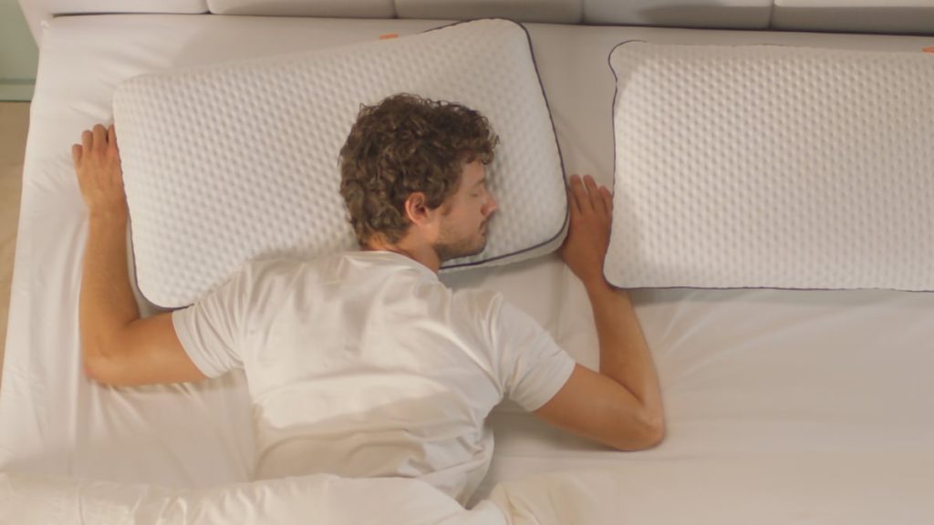 Man lying on his front with his head on an Emma Adapt Cooling Pillow