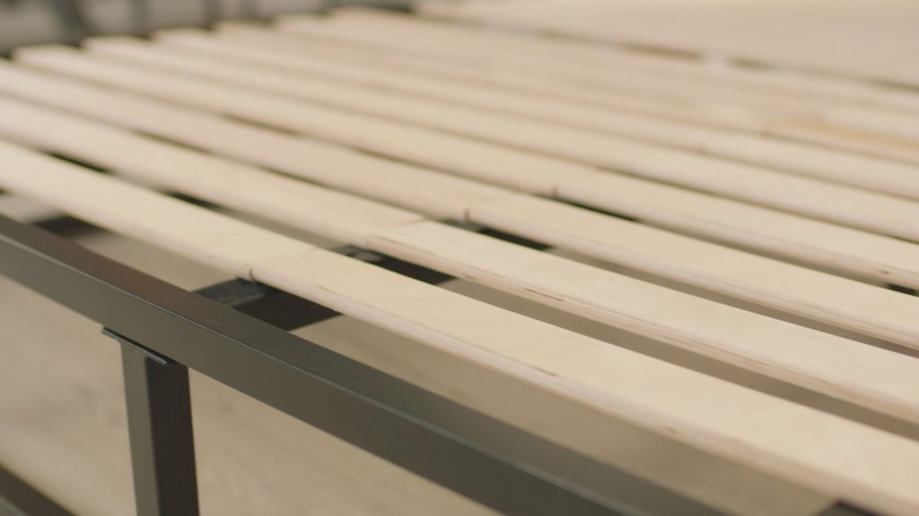Emma Metal Bed close-up of the birch plywood slats resting on the black metal rail