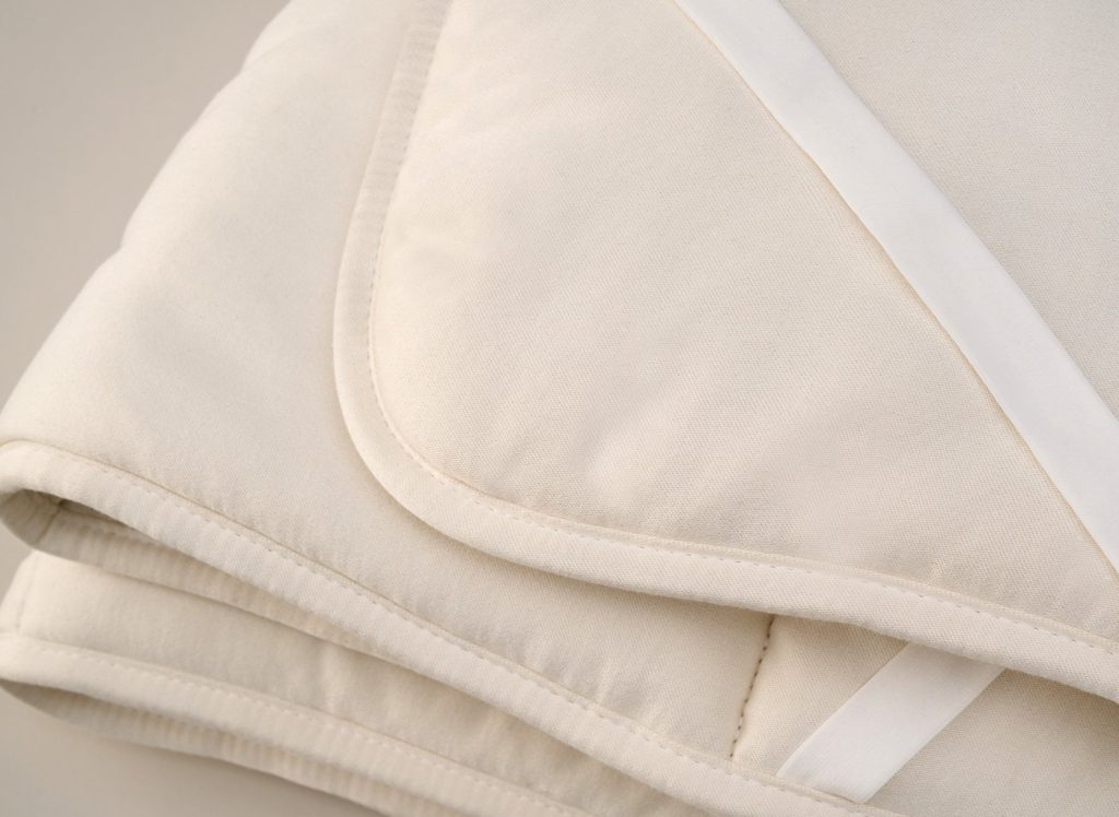 Close-up of the Flaxby Quilted Wool Mattress Enhancer edge and corner strap