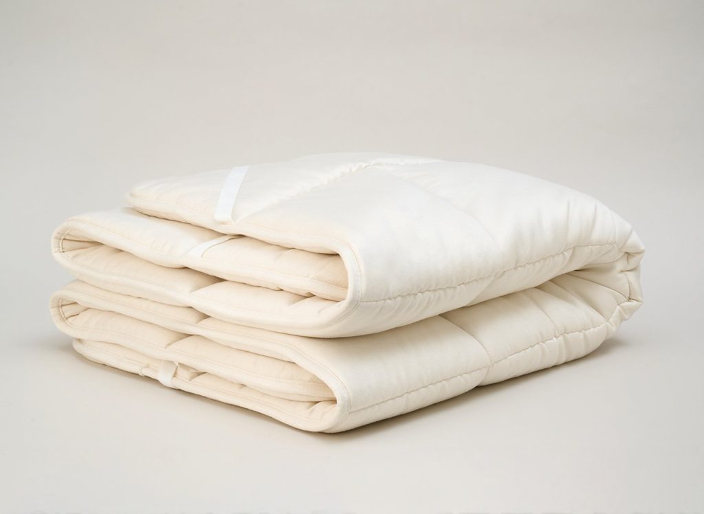 Flaxby Quilted Wool Mattress Enhancer folded on a plain background