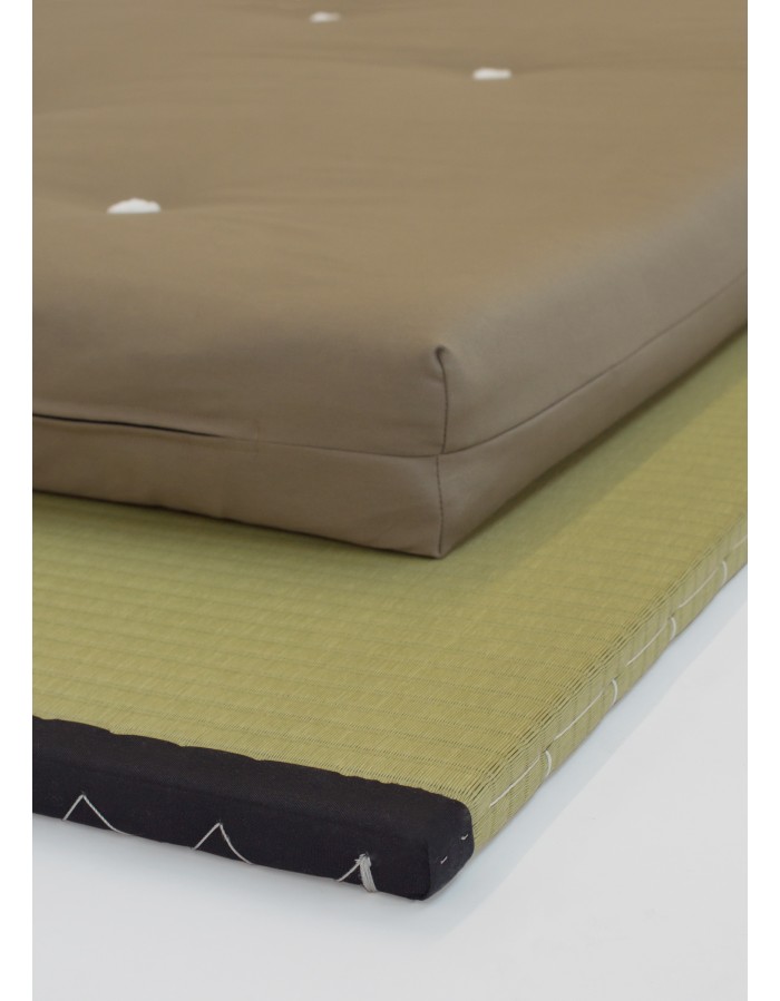 Close-up of a Futons247 Monk bed roll edge and felt tufts on a tatami mat