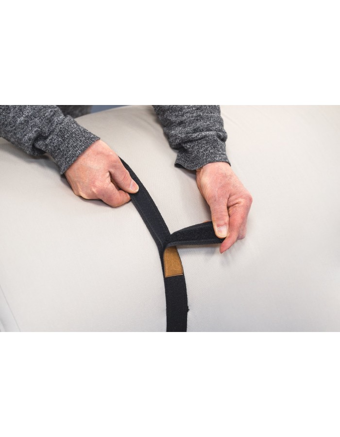Hands fastening the storage strap of a rolled Futons247 Neru futon