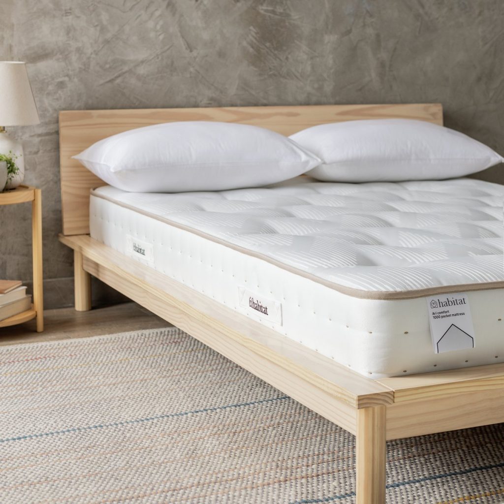 Habitat Ari Natural 1000 Pocket Comfort mattress on a wooden bed frame with pillows