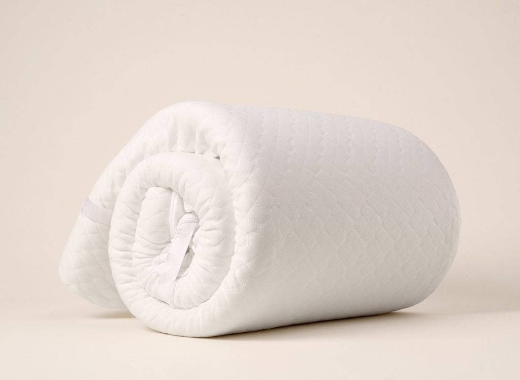 Hyde & Sleep Memory Foam Mattress Topper rolled up on a plain background