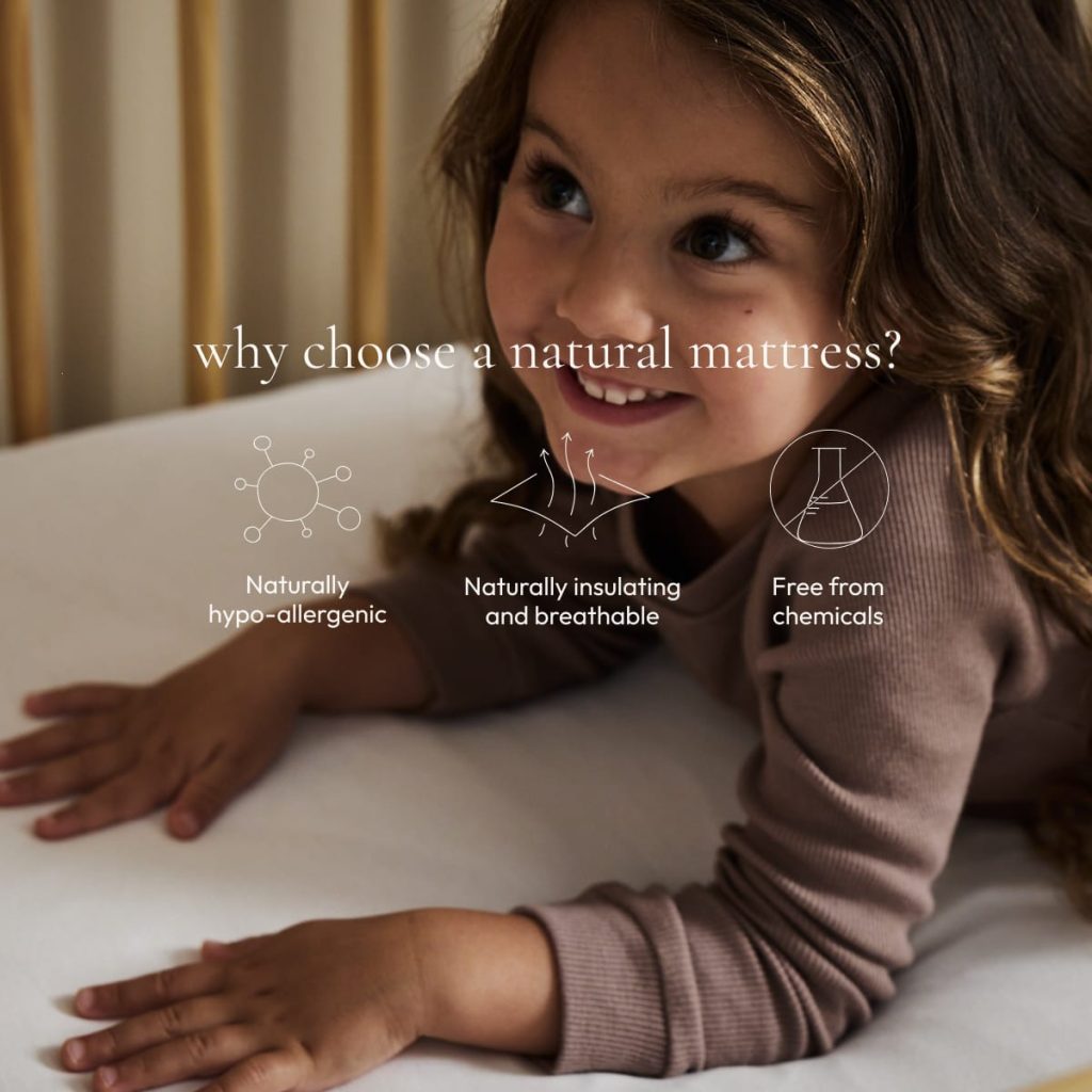 Child lying on The Little Green Sheep Natural Junior Mattress with natural material icons