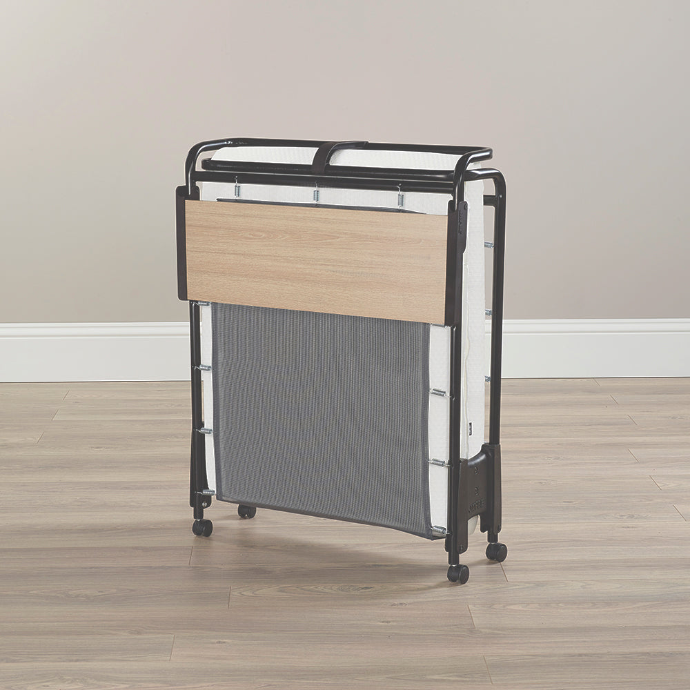 Jay-Be Revolution Folding Bed folded upright on its castors