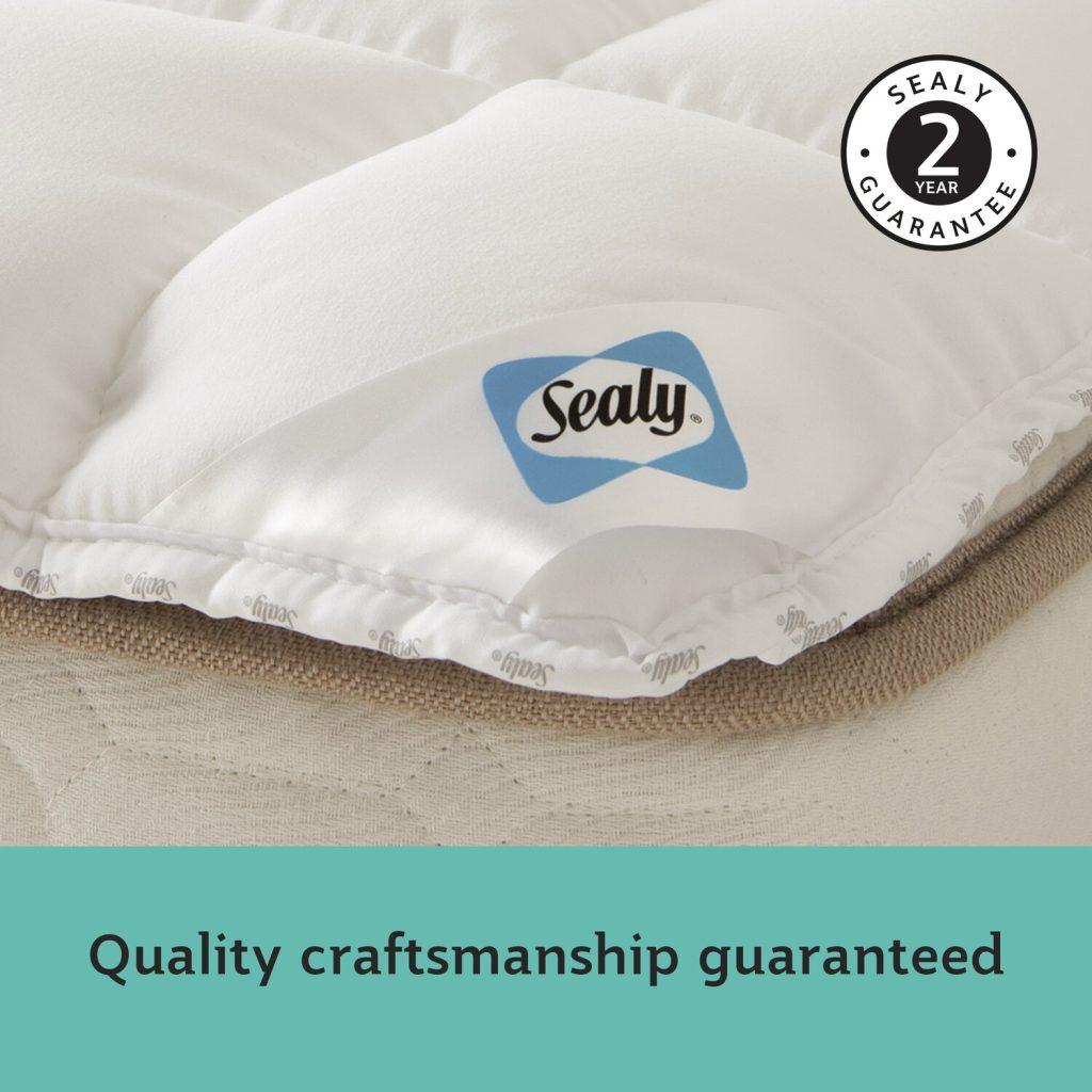 Close-up of the Sealy satin sash label on the topper edge