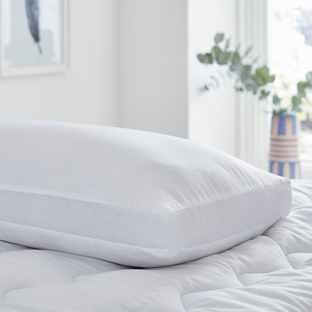 Silentnight Airmax Pillow on a white bed, showing the mesh side wall