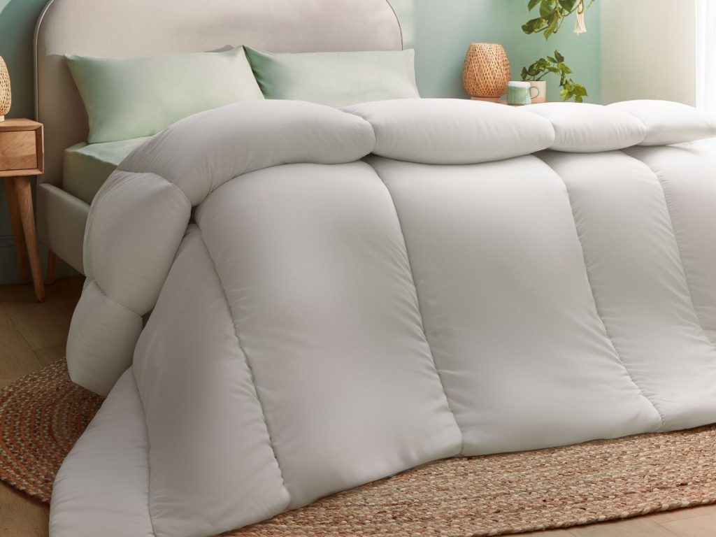 Silentnight Anti-Allergy duvet on an upholstered bed with green pillows