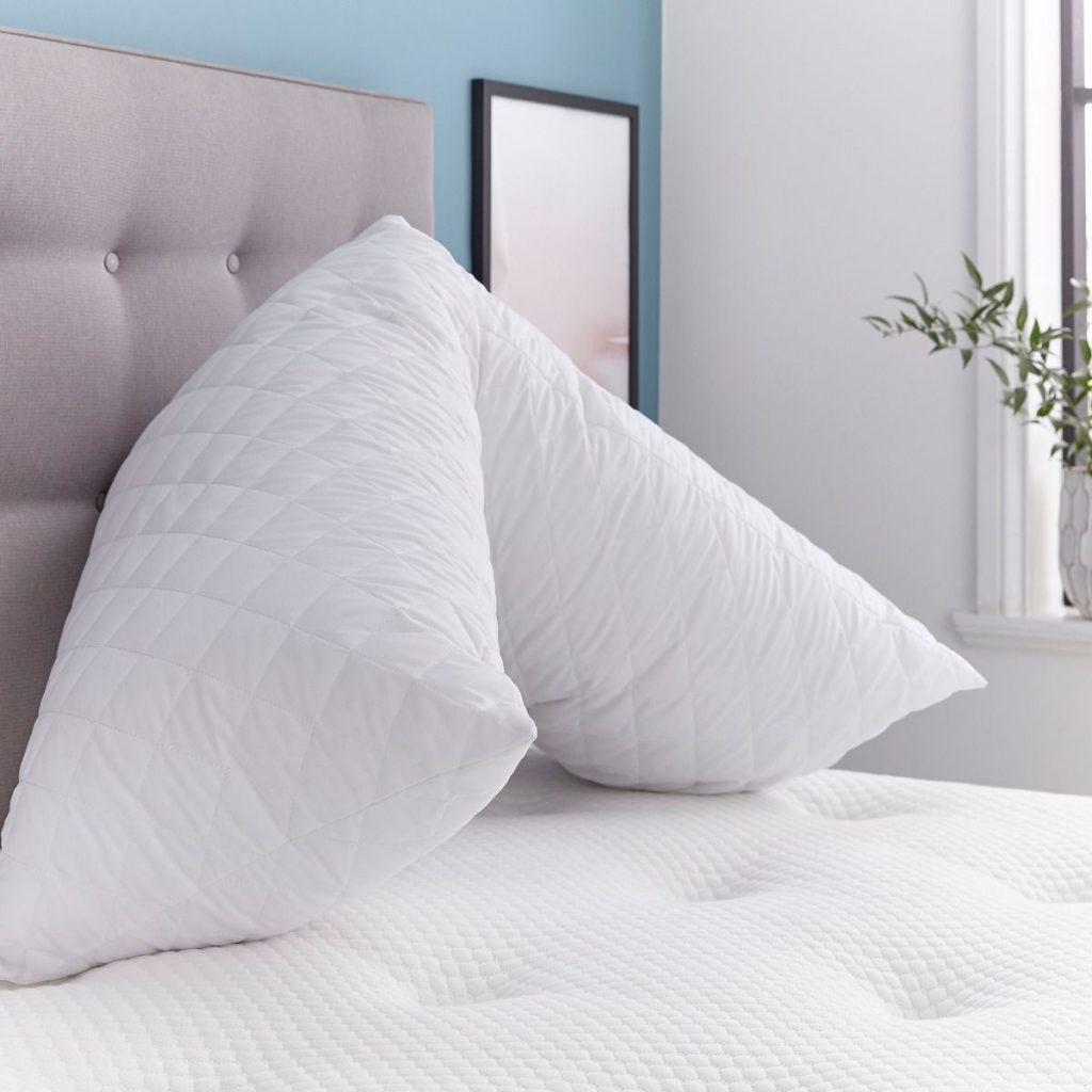 Silentnight Body Support Pillow folded on a mattress, showing its quilted cover