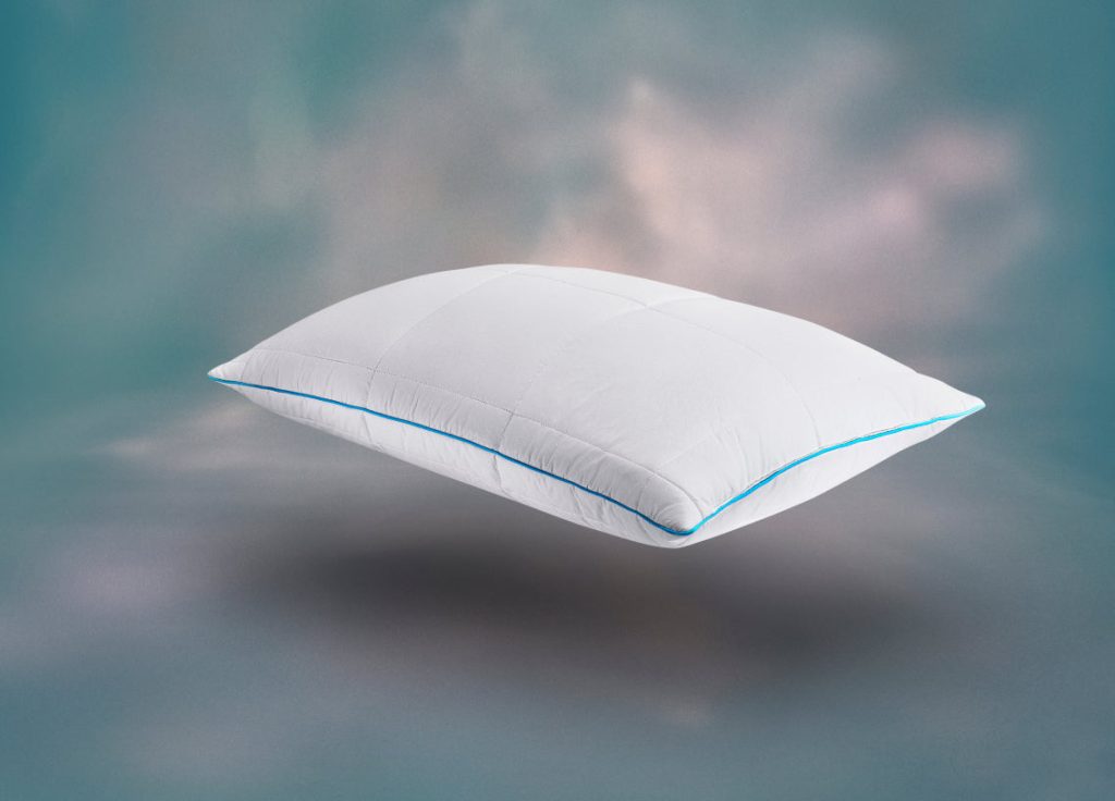 Simba AeroDown Pillow in a quilted white cotton cover with blue piping against a blue-grey backdrop