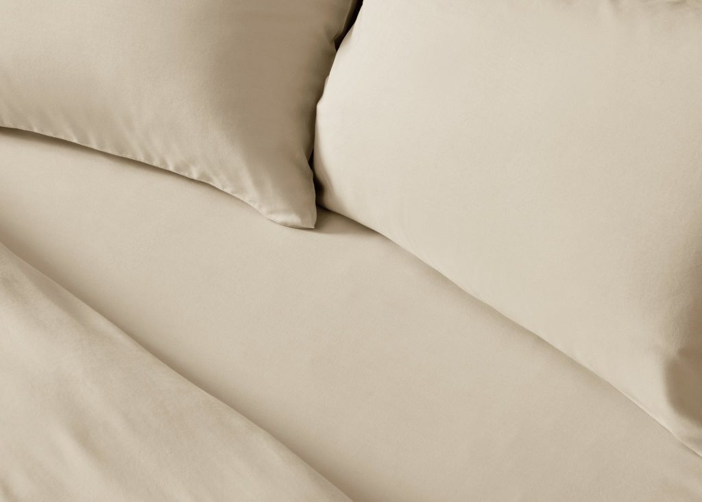 Simba Brushed Tencel Fitted Sheet on a made bed, close view of the fabric