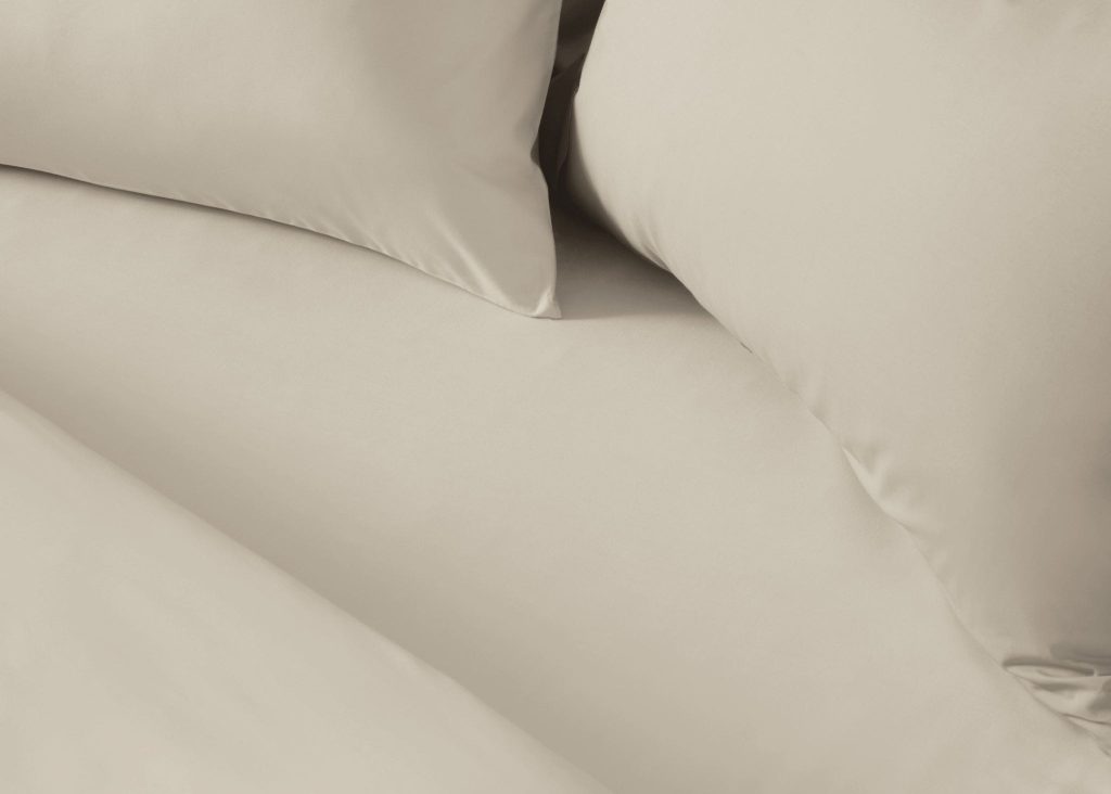 Simba Cotton Percale Fitted Sheet on a made bed, close view of the fabric