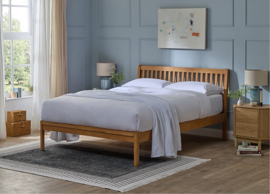 Simba Sherwood Solid Ash Bed in a blue bedroom with grey bedding