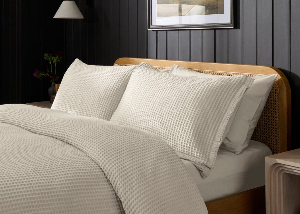 Simba Waffle Cotton Pillowcase Pair on a made bed in a bedroom