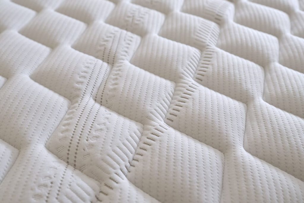 Close-up of the quilted knitted cover of the Sleepeezee InMotion Eco mattress