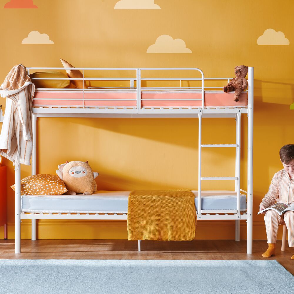 Child reading beside a bunk bed fitted with Silentnight Healthy Growth bunk mattresses