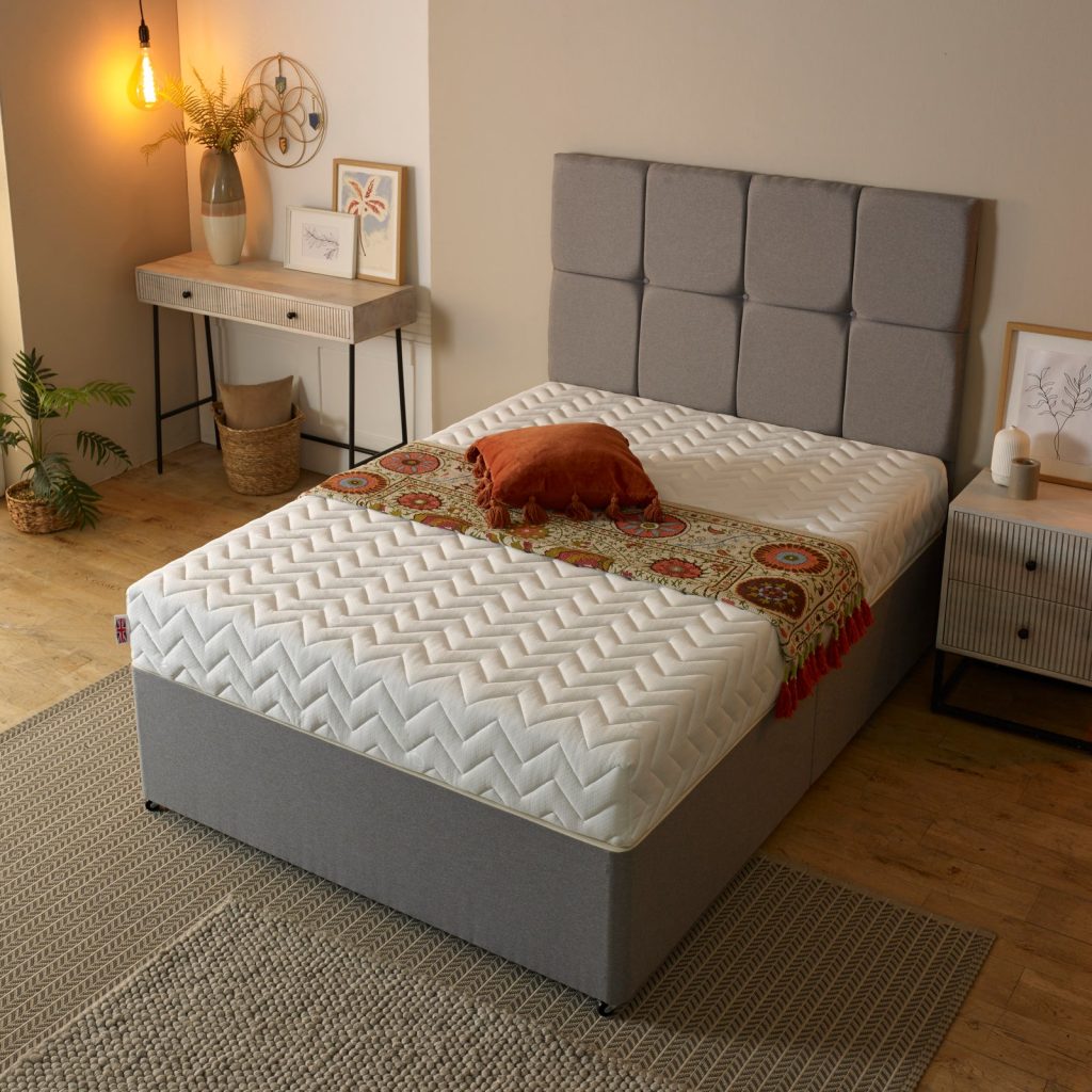 Starlight Beds Harmony 3-Layer mattress on a grey divan bed with a buttoned headboard