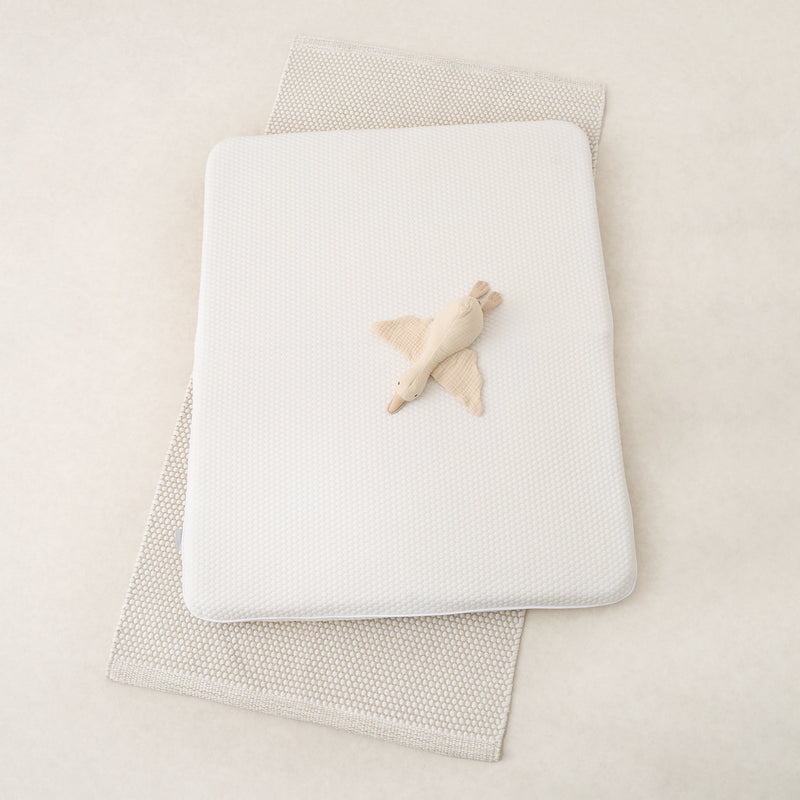 Tiny Dreamer Natural travel cot mattress folded in half