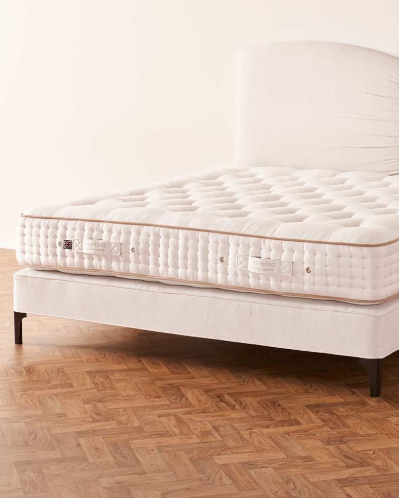 Vispring Sublime Superb mattress on a cream upholstered divan with headboard